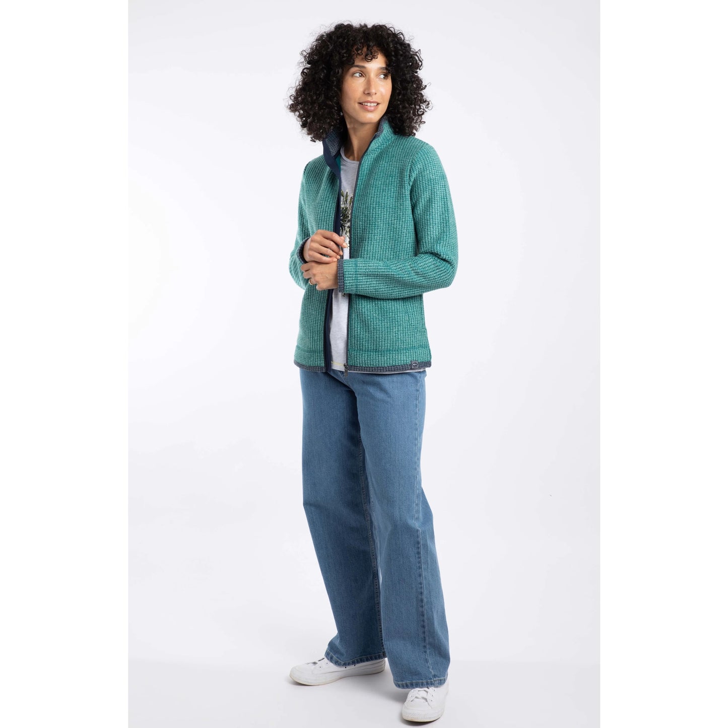 Weird Fish womens Ariana zip grid fleece green worn by woman with curly hair paired with jeans and white sneakers