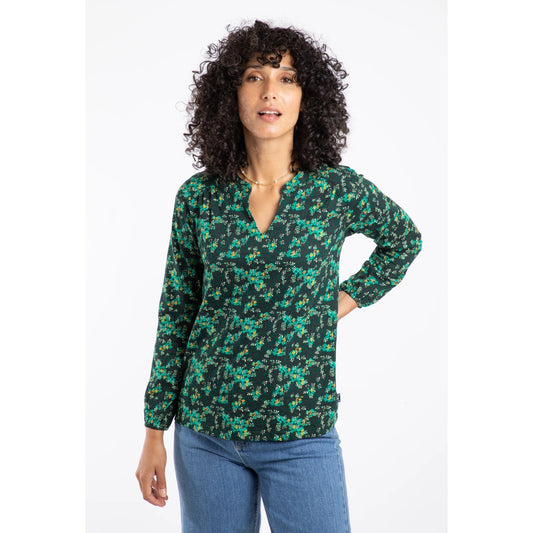 Woman wearing a green floral Weird Fish Brooke long-sleeve top on a white background