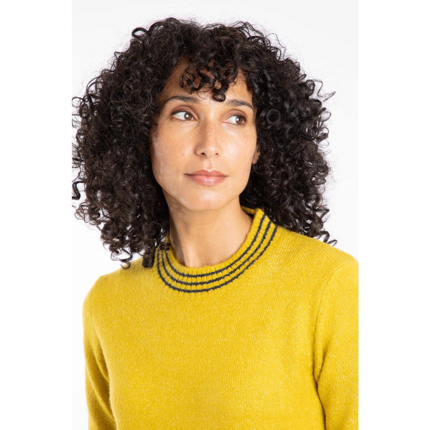 Woman wearing a yellow Weird Fish jumper with stripe neckline on a white background