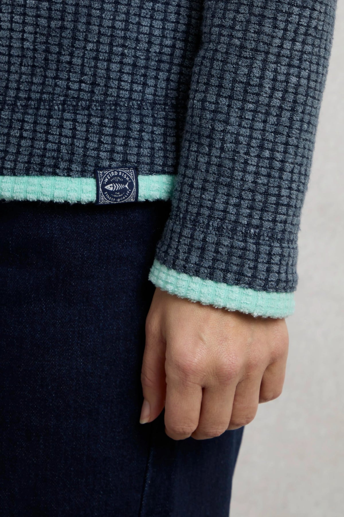 Weird Fish womens fleece navy with textured fabric and mint trim on sleeve and hem
