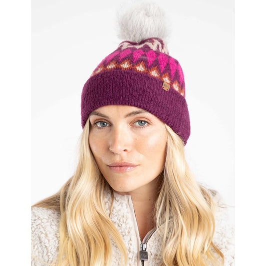 Woman wearing a Weird Fish beet purple Frady knit beanie with a Fair Isle pattern and bobble on a white background