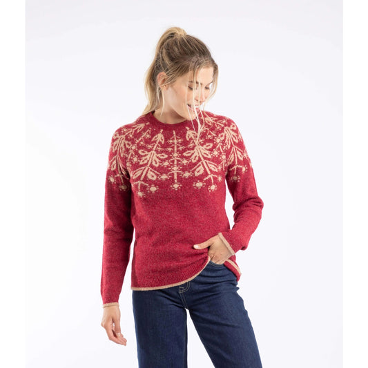 Front view of a woman wearing a red Weird Fish Miska knitted jumper with a beige Fair Isle pattern and beige trousers.