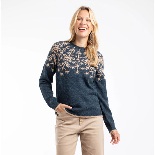 Front view of a woman wearing a navy Weird Fish Miska knitted jumper with a beige Fair Isle pattern and beige trousers.