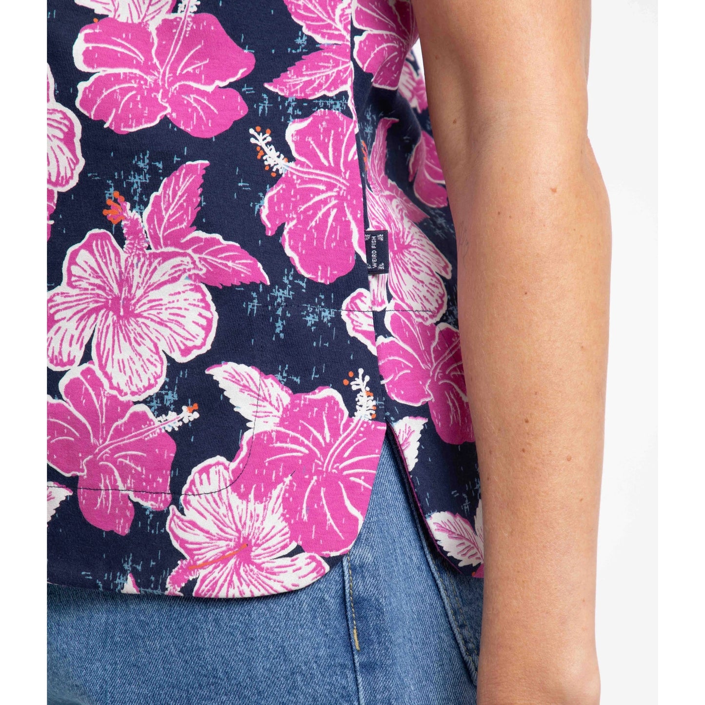 Close-up of the side hem slit of a womans Weird Fish Paw Paw t-shirt in Fuschia Punch pink floral pattern