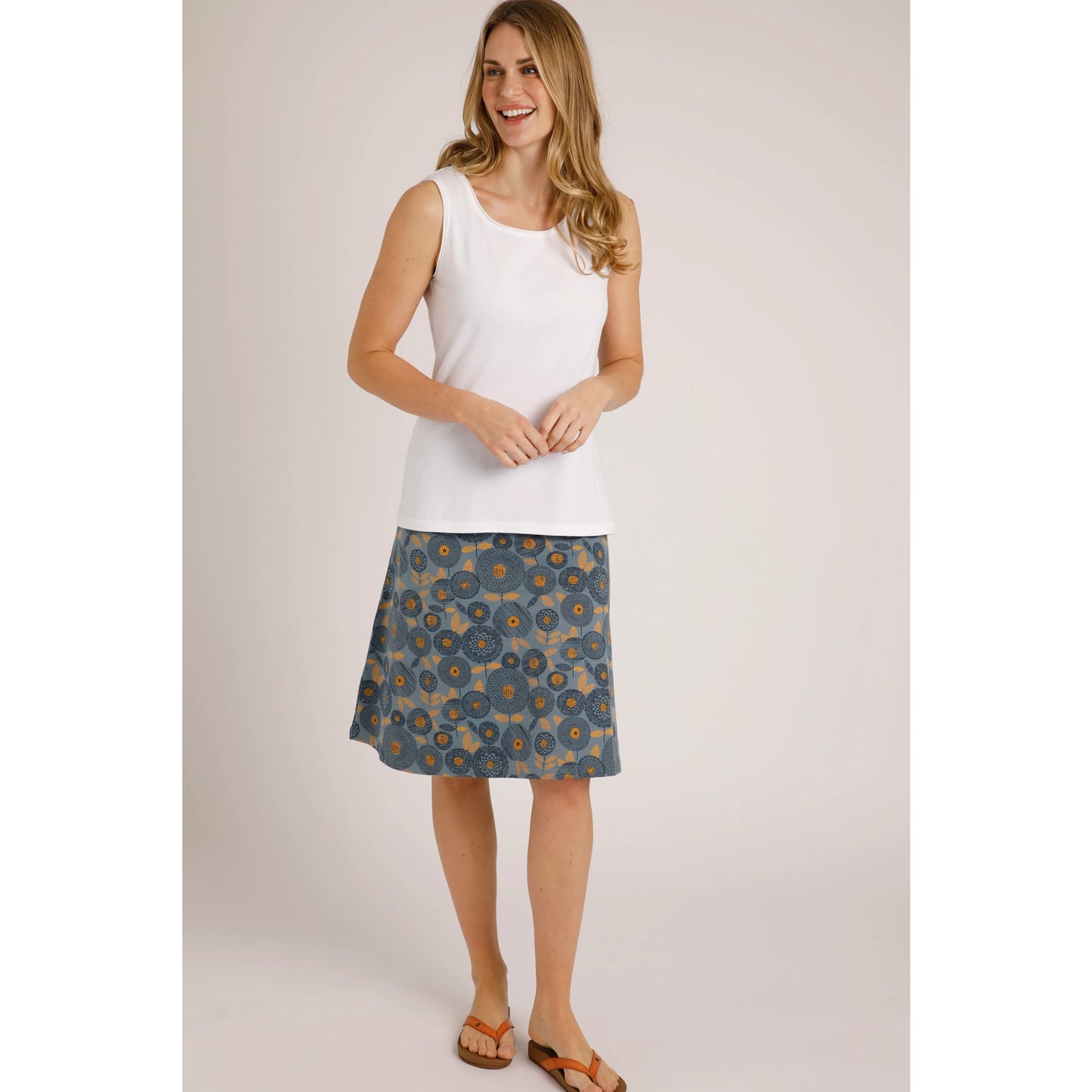 Weird Fish womens plain white Calle vest worn by smiling woman with floral skirt and sandals