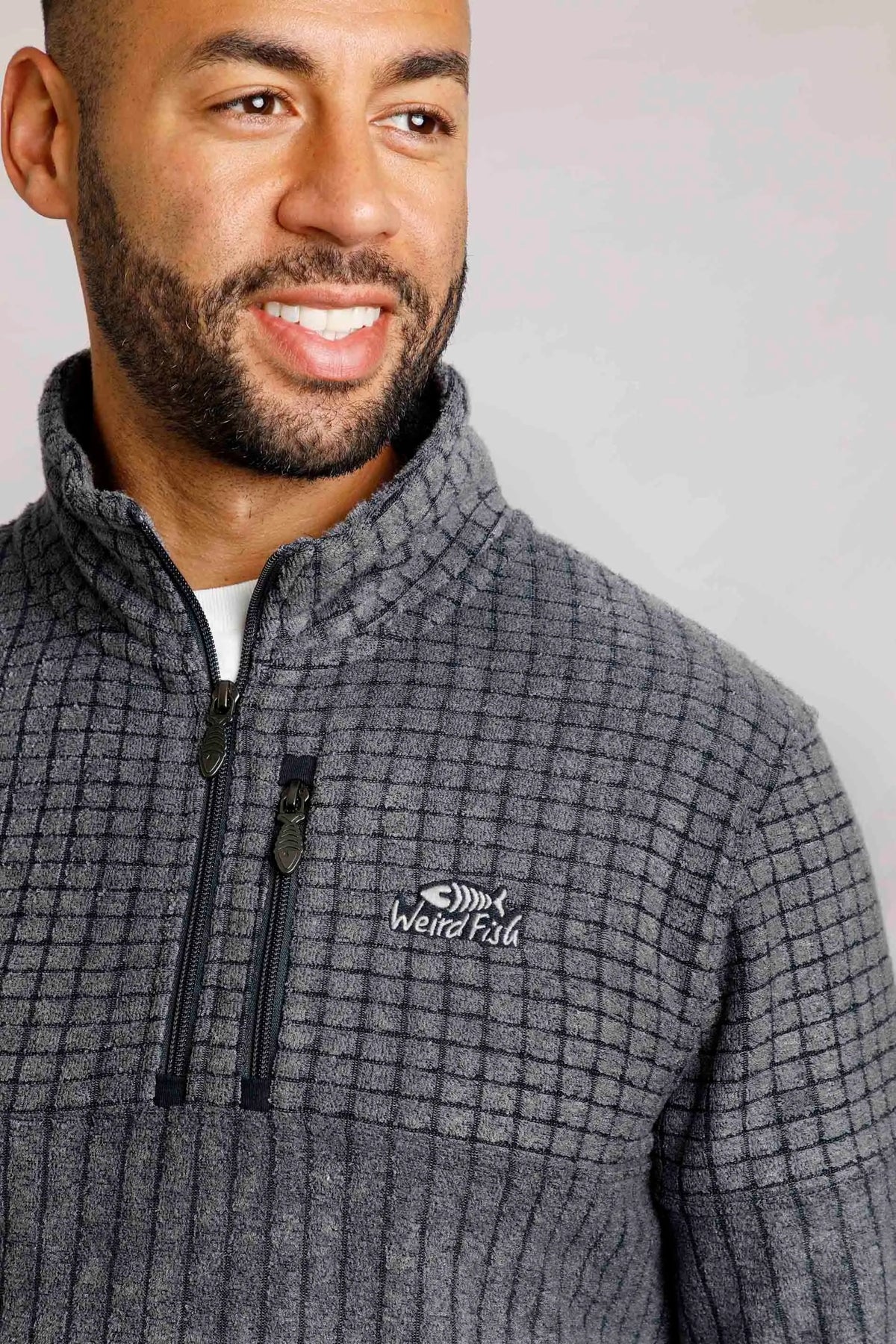 Weird Fish men's Longmont stripe grid textured fleece with chest zip pocket and logo.