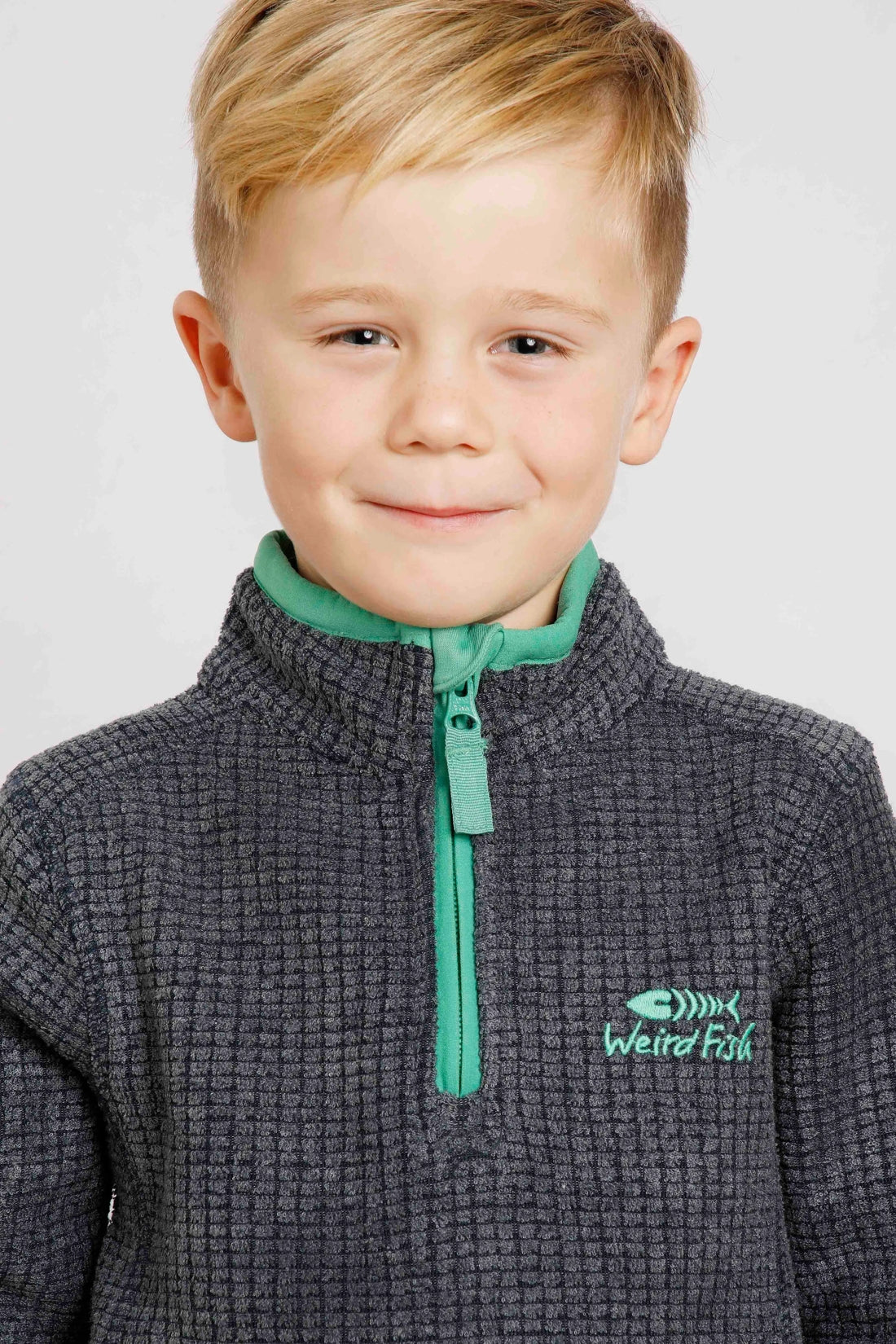 Weird Fish childrens Archie 1/4 zip grid fleece in Navy with green trim.