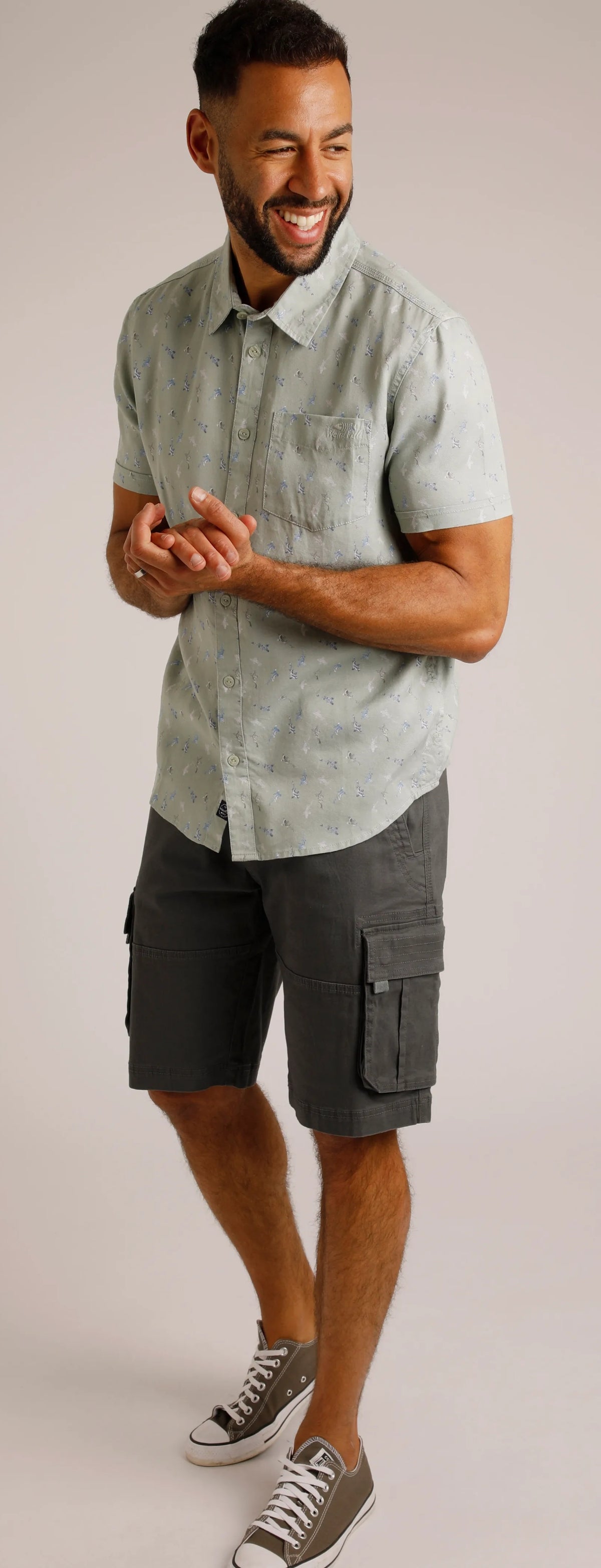A fish print men's shirt from Weird Fish, the Keilor shirt in pistachio green has short sleeves, button through front and is made from a Tencel fabric.