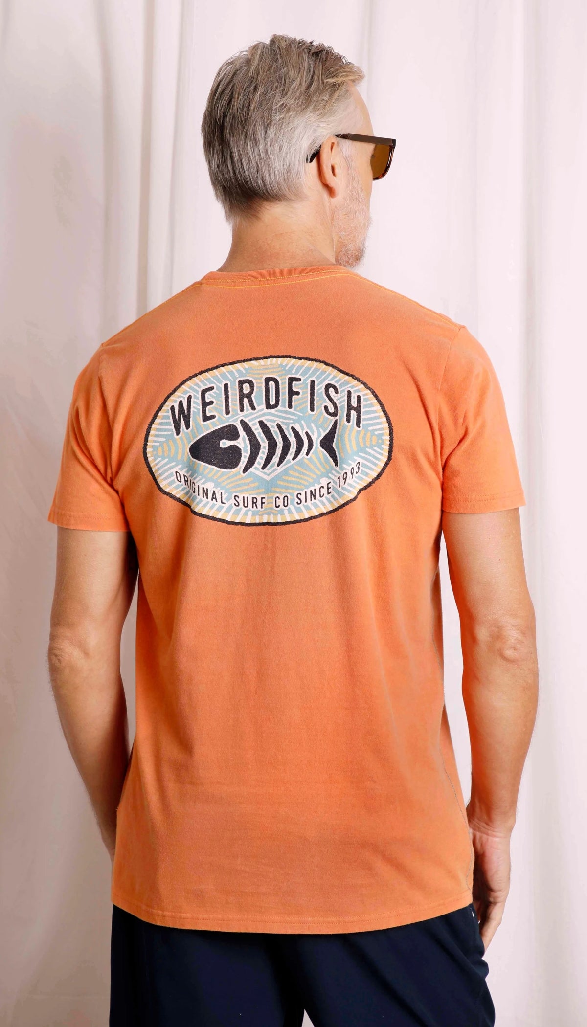 Original Print logo design men's tee from Weird Fish in Mango Orange.