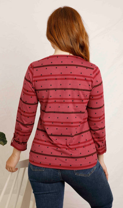 The women's Billie long sleeve t-shirt from Weird Fish in Crushed Berry with a stripe and dotty pattern, made from an organic cotton fabric with a crew neckline and roll up sleeves.