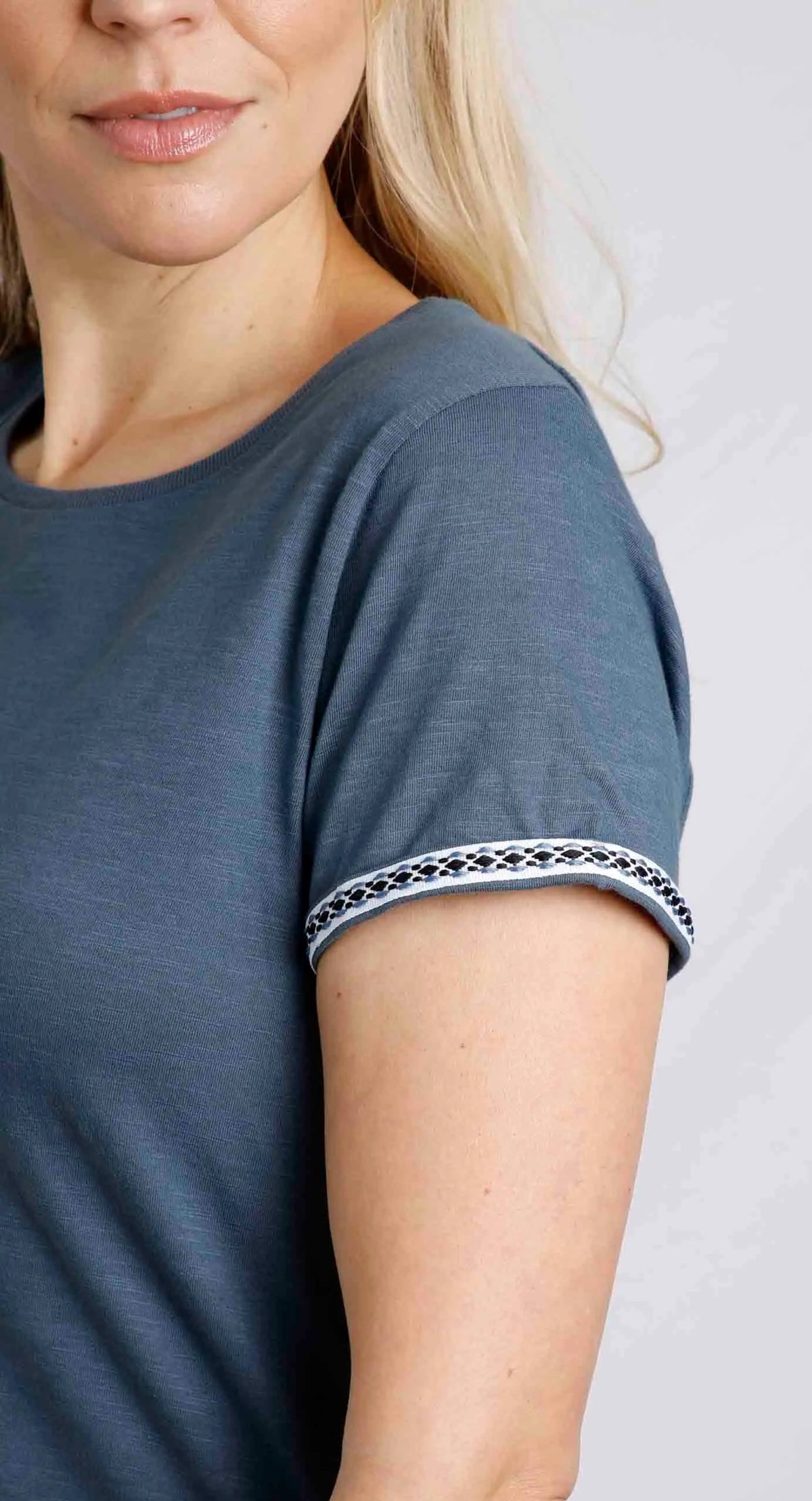 Women's short sleeve Teya tee in China Blue with embroidered tape sleeve trim.