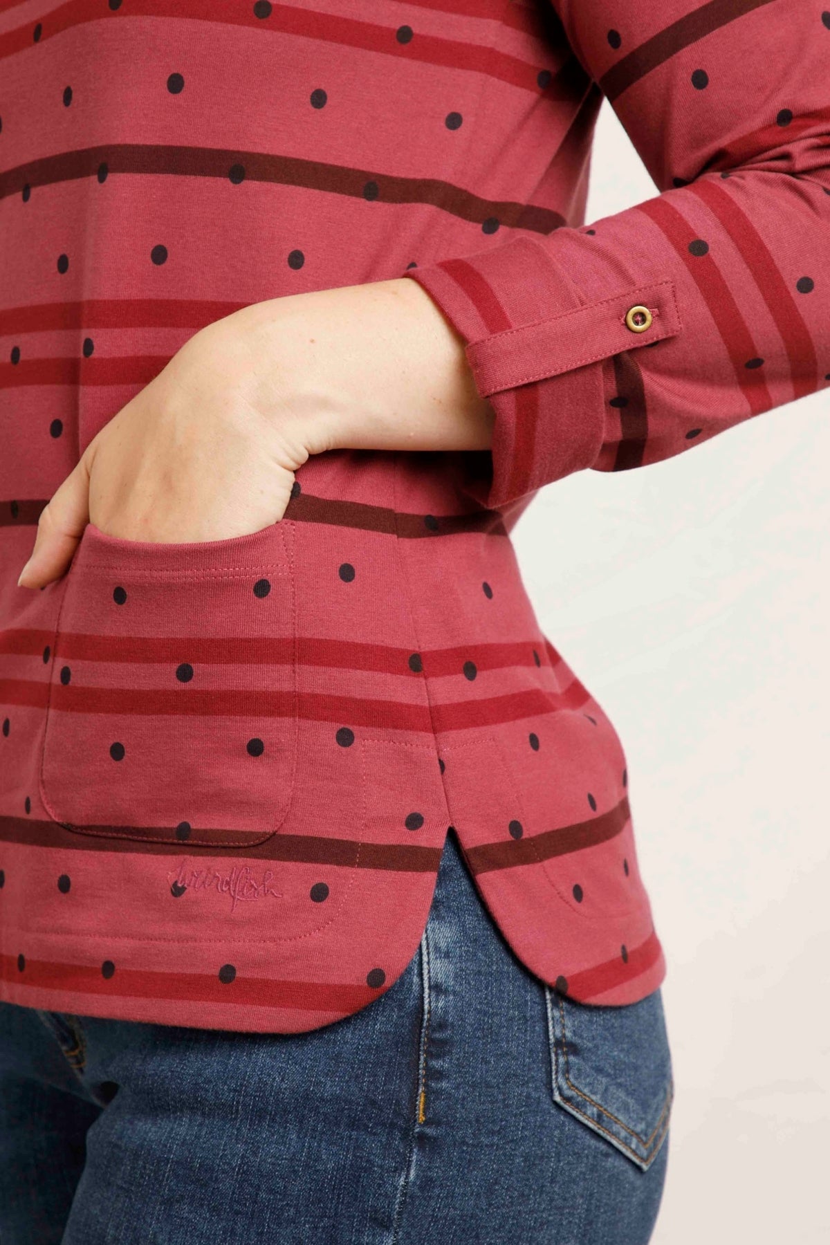A women's crew neck long sleeve Billie t-shirt from Weird Fish in Crushed Berry with a stripe and dotty pattern, made from an organic cotton fabric with roll up sleeves.