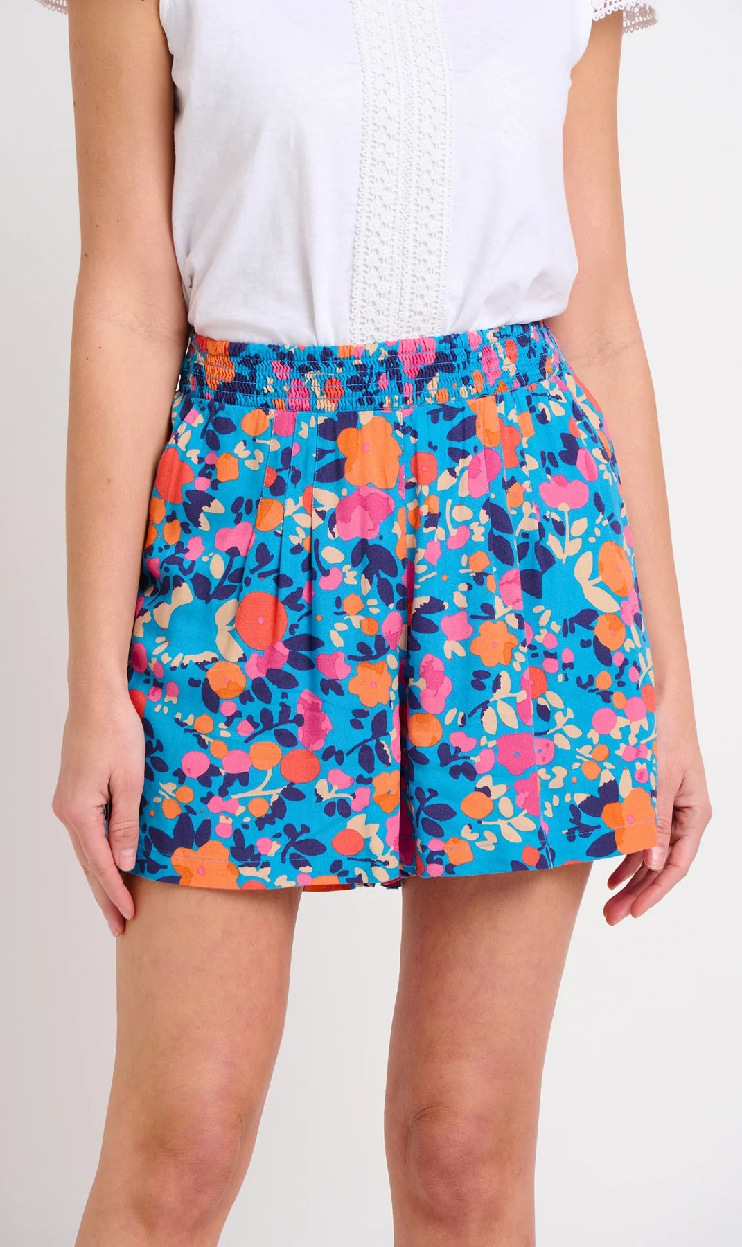 Front view of Brakeburn womens Bloom floral print shorts in blue with orange and pink flowers and elastic waistband
