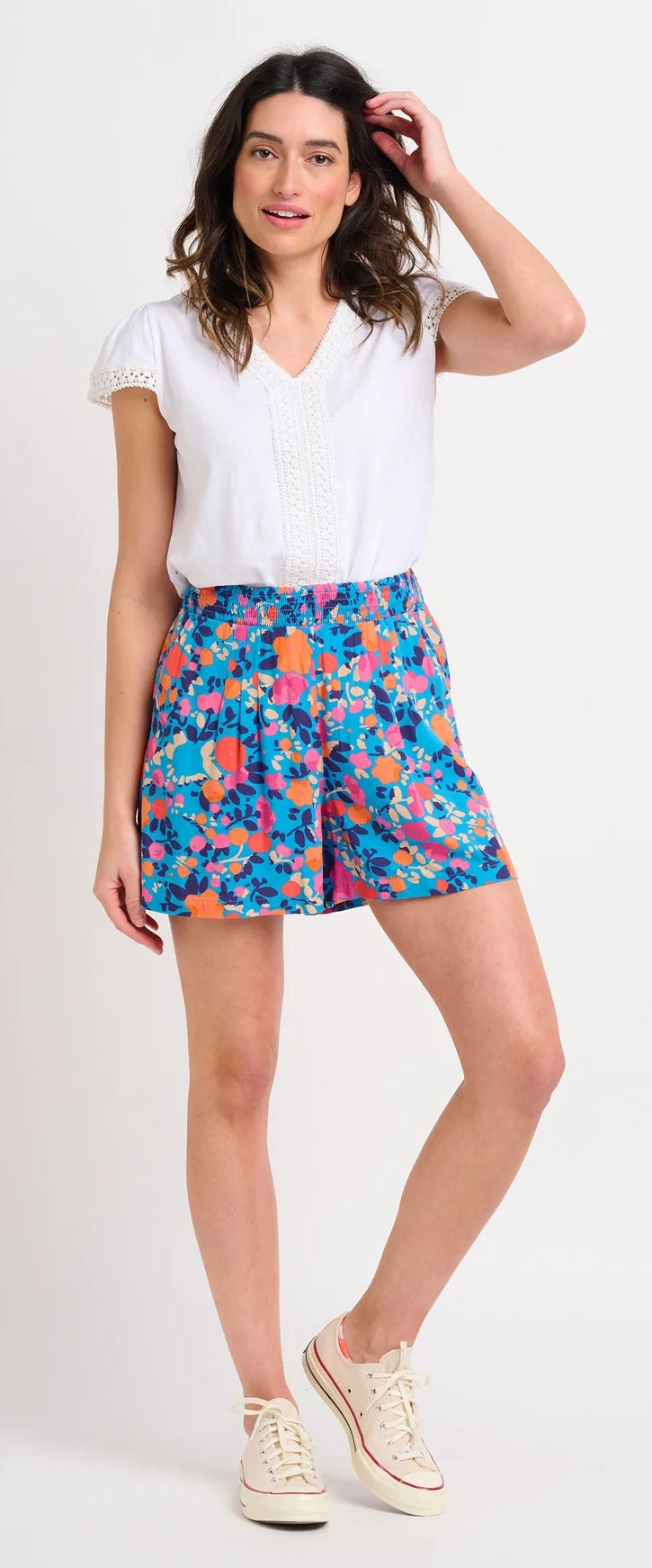 Brakeburn womens Bloom floral print shorts worn by a woman paired with a white blouse and white sneakers