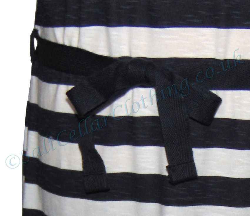 Close-up of Captain Corsaire white navy stripe dress featuring a tied navy blue waist belt