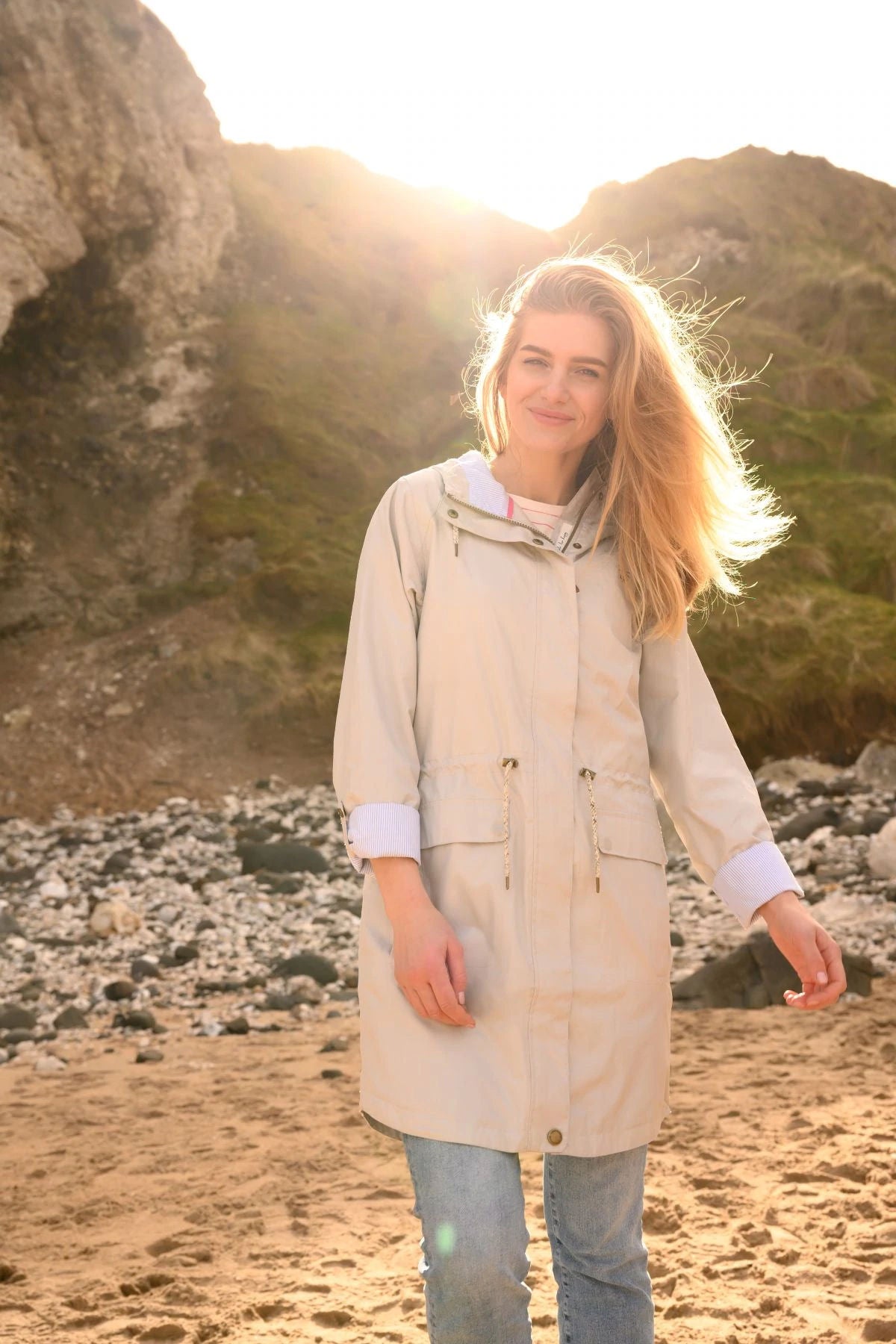 Women's Lighthouse Alice waterproof rain coat in Sand with drawstring waist and roll back sleeves.