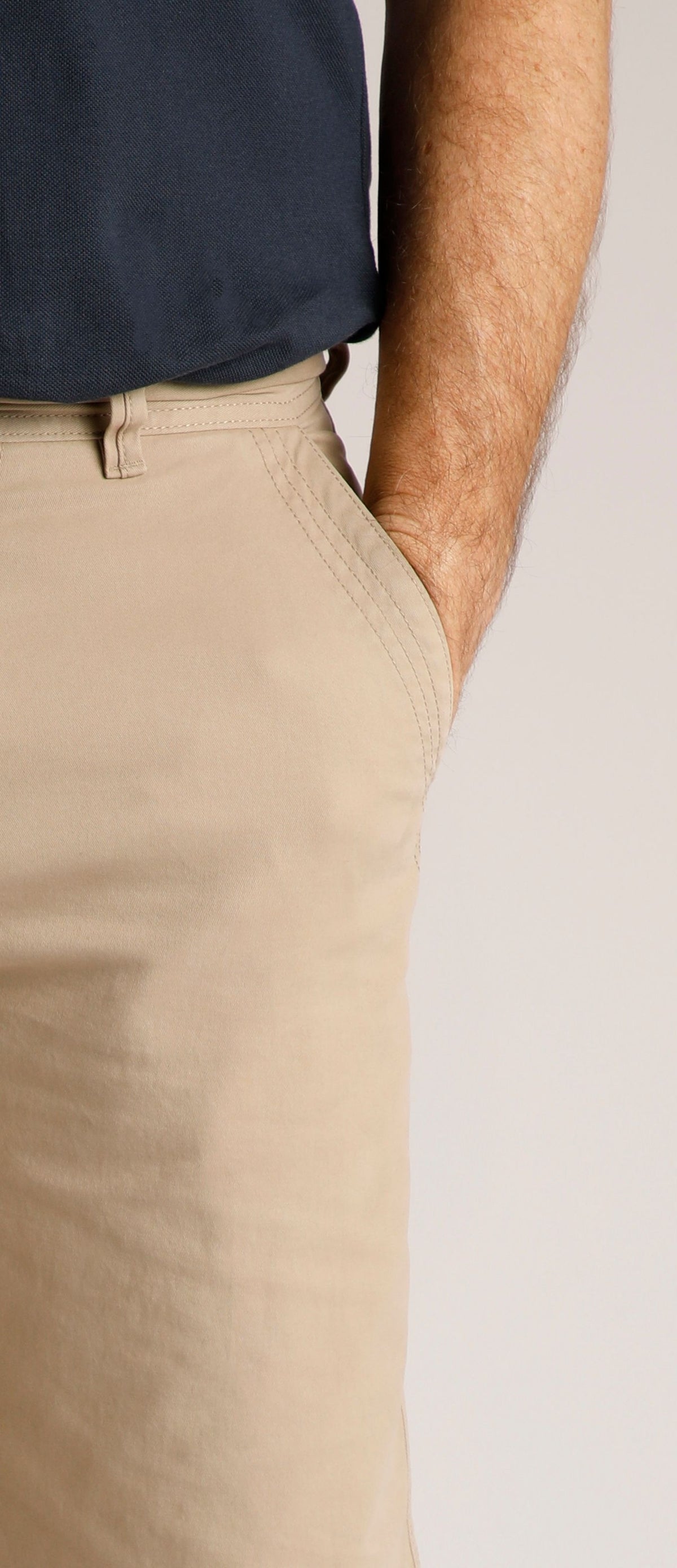 Weird Fish mens Rayburn chino shorts Taupe Grey worn by model with hand in pocket and navy shirt