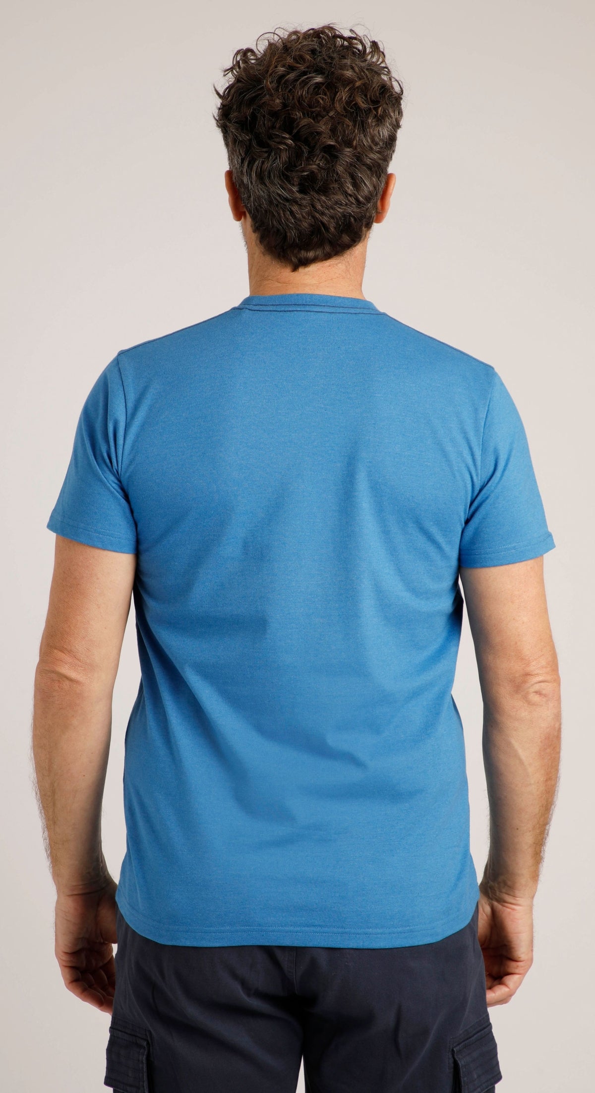 Back view of a blue Weird Fish mens t-shirt showcasing a comfortable fit and casual style