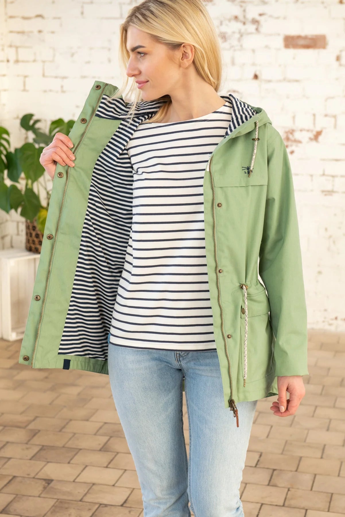 Alicia women's waterproof jacket from Lighthouse in Pistachio Green with white and navy stripe lining.