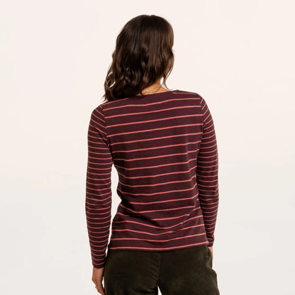 Back view of a woman wearing a Brakeburn long sleeve thick and thin stripe Branksome t-shirt in burgundy with coral stripes.