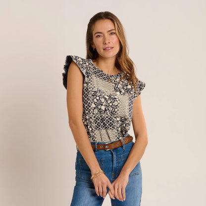 Front view of a woman wearing a Brakeburn short sleeve Salinas blouse in a cream and navy patchwork floral print