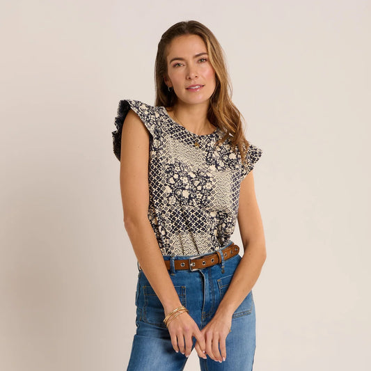 Front view of a woman wearing a Brakeburn short sleeve Salinas blouse in a cream and navy patchwork floral print