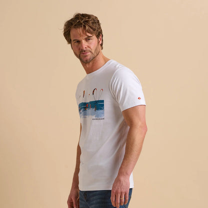 Side view of a man wearing a Brakeburn short sleeve t-shirt in white with a Watersports print on a beige background