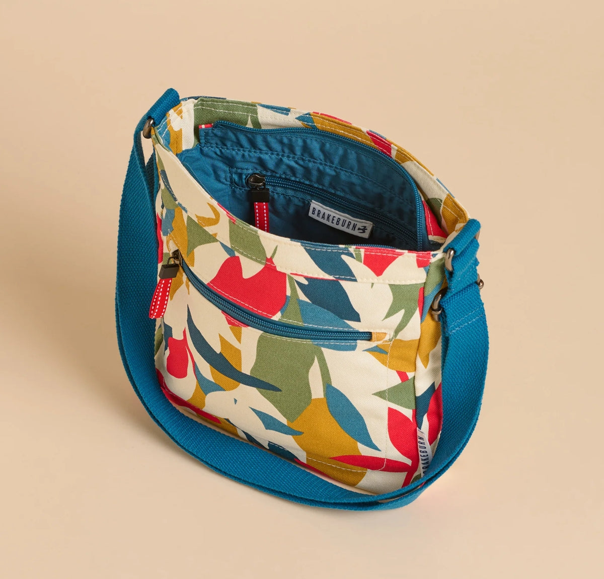 Brakeburn multicoloured cross body bag falling leaves pattern with blue adjustable strap and multiple compartments