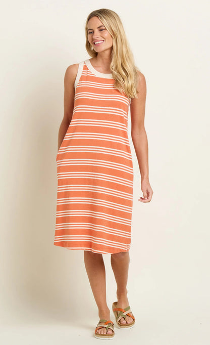 Brakeburn sleeveless stripe dress in orange and white worn by smiling woman with sandals