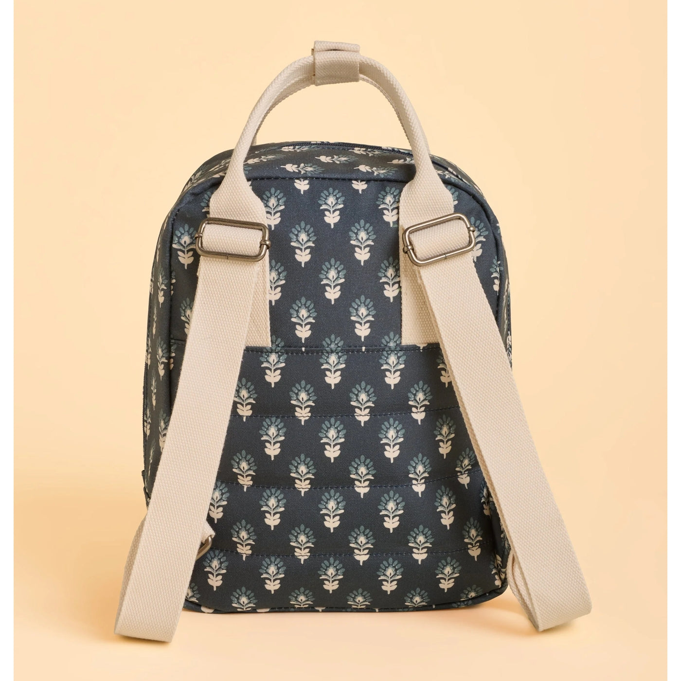 Brakeburn navy Henna floral patterned backpack with beige straps on a beige background