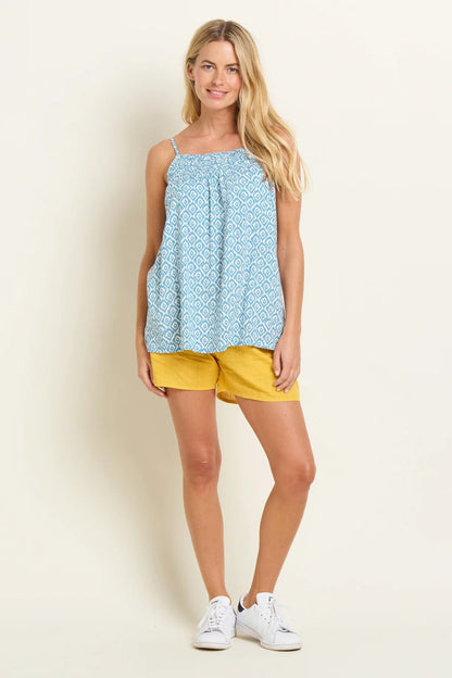 Brakeburn womens blue camisole vest with geometric pattern worn with yellow shorts and white sneakers