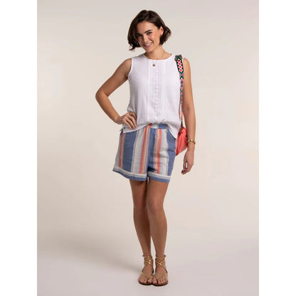 Front view of a woman wearing a pair of Brakeburn Constanza beach shorts in a blue and coral vertical stripe pattern with an elastic waist.
