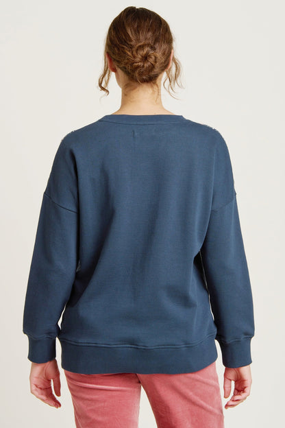 Brakeburn womens crew sweatshirt blue shown from the back on a model with long sleeves and relaxed fit