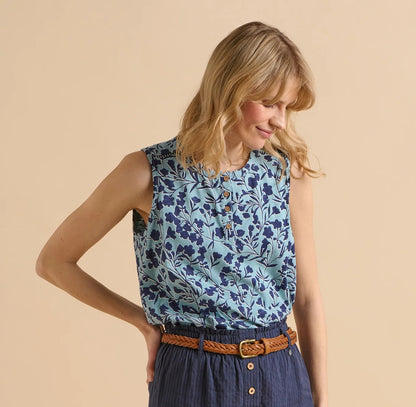 Front view of a woman wearing a sleeveless Brakeburn Shadow Floral Vest top in a two tone blue pattern, on a beige background