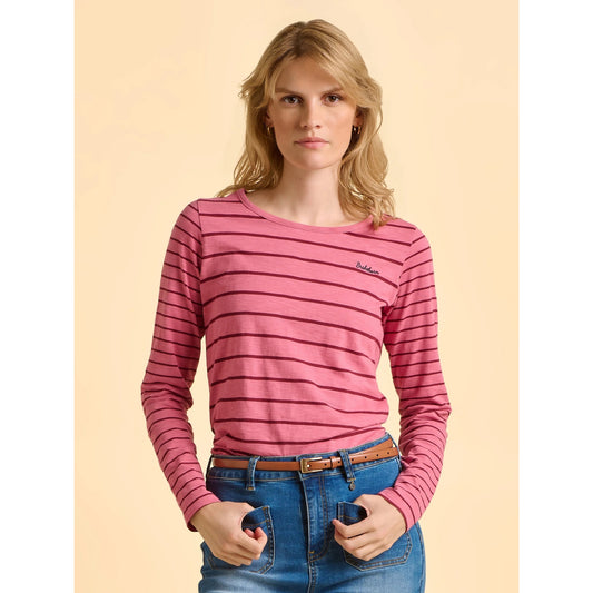 Woman wearing a pink striped long-sleeve shirt against a beige background