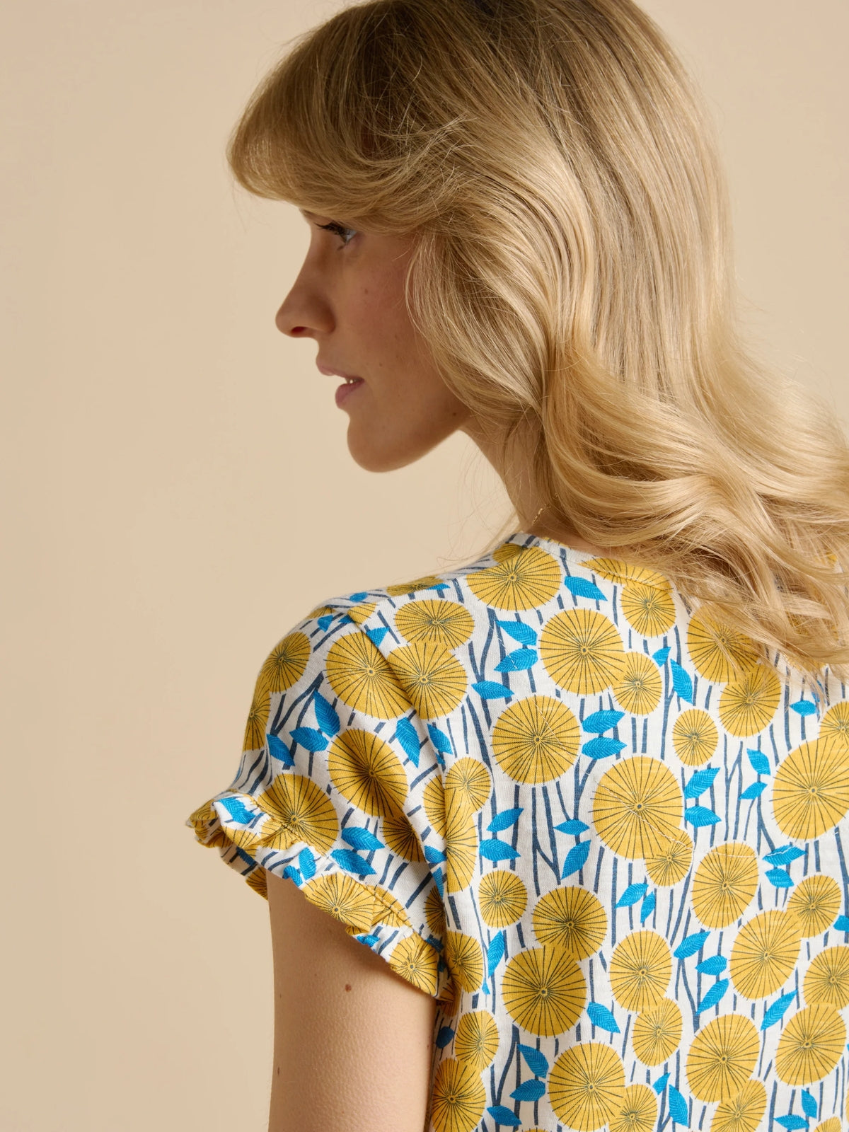 Brakeburn womens yellow t-shirt with blue floral pattern and ruffled sleeves on model back view