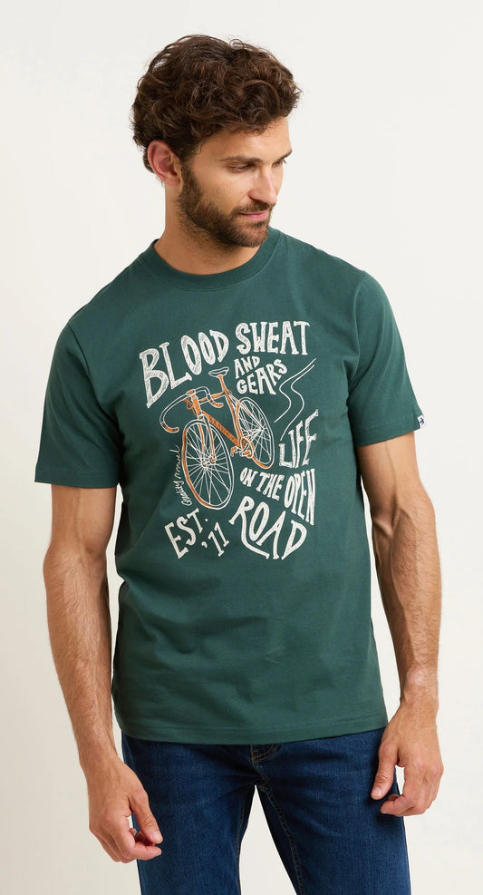 A men's tee from Brakeburn in khaki green featuring a bicycle themed Blood Sweat and Gears print.