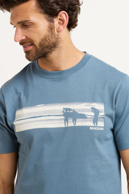 Half tone surf print across the t-shirt chest featuring waves and surfer silouettes.