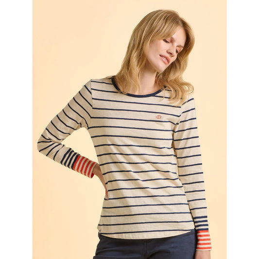 Woman wearing a Brakeburn striped long-sleeve cream Knoll t-shirt on a beige background