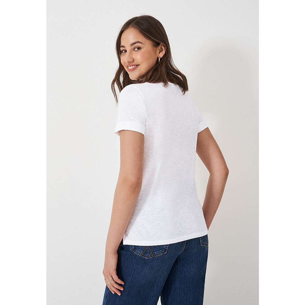 Back view of a woman wearing a Crew Clothing Perfect short sleeve plain t-shirt in white with blue jeans