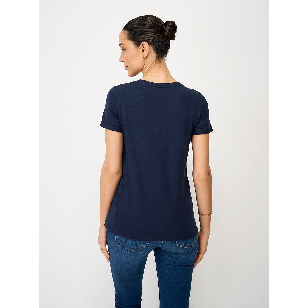 Back view of a woman wearing a Crew Clothing Perfect short sleeve plain t-shirt in navy with blue jeans