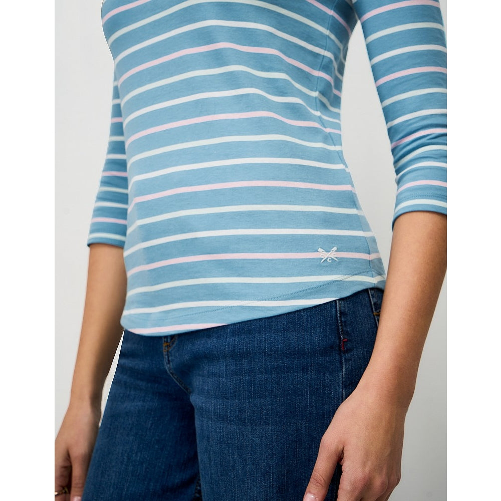 Close-up view of a woman wearing a Crew Clothing Essential Breton 3/4 sleeve t-shirt in Delph Blue with pale pink and white stripes.
