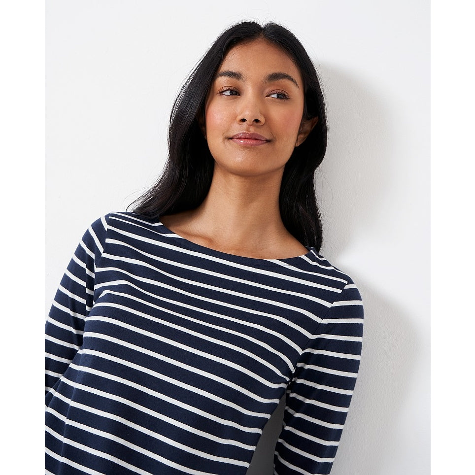Close-up view of a woman wearing a Crew Clothing Essential Breton 3/4 sleeve t-shirt in navy with white stripes.