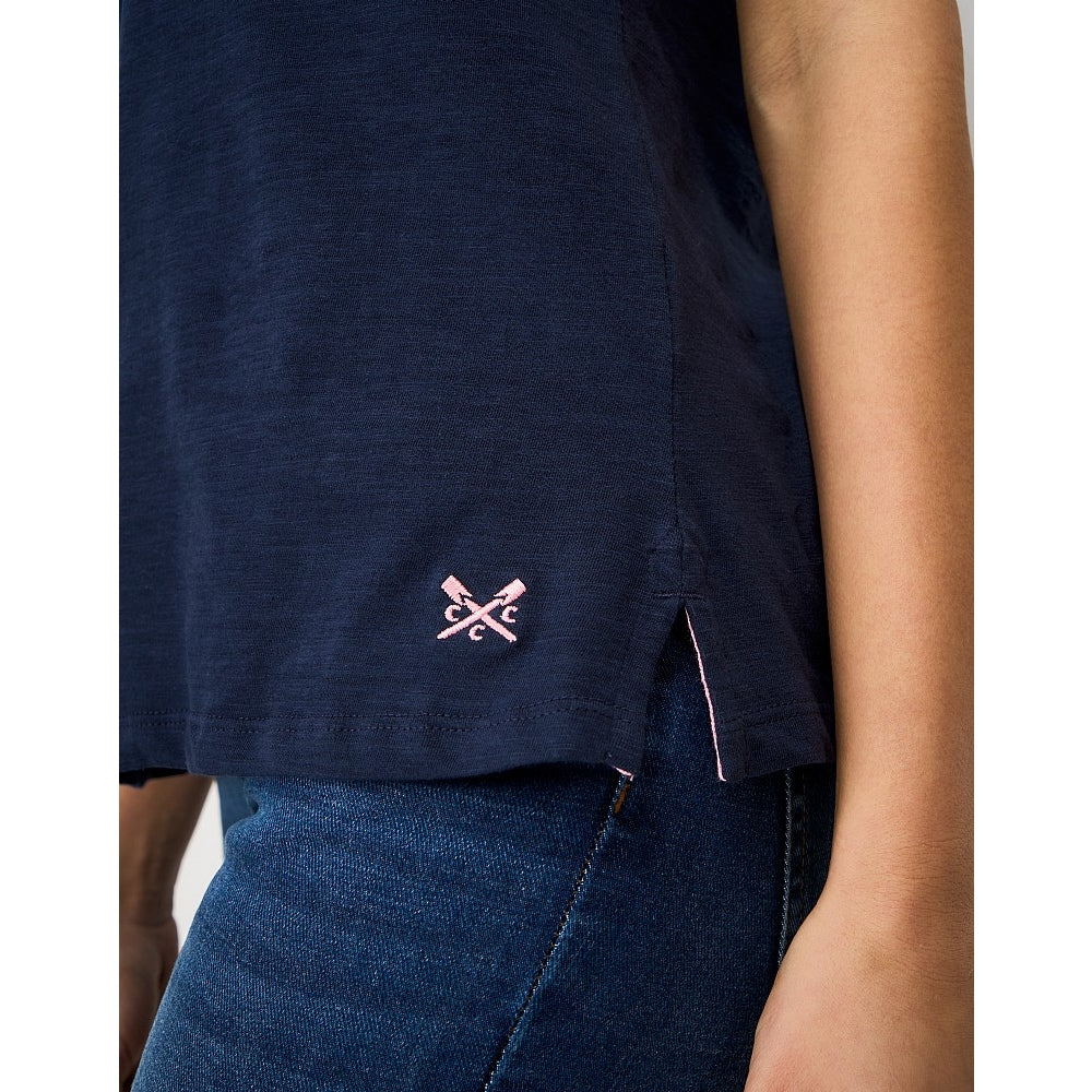 Woman wearing a Crew Clothing Perfect short sleeve plain t-shirt in navy with small embroidered logo by the hem and side seam slits