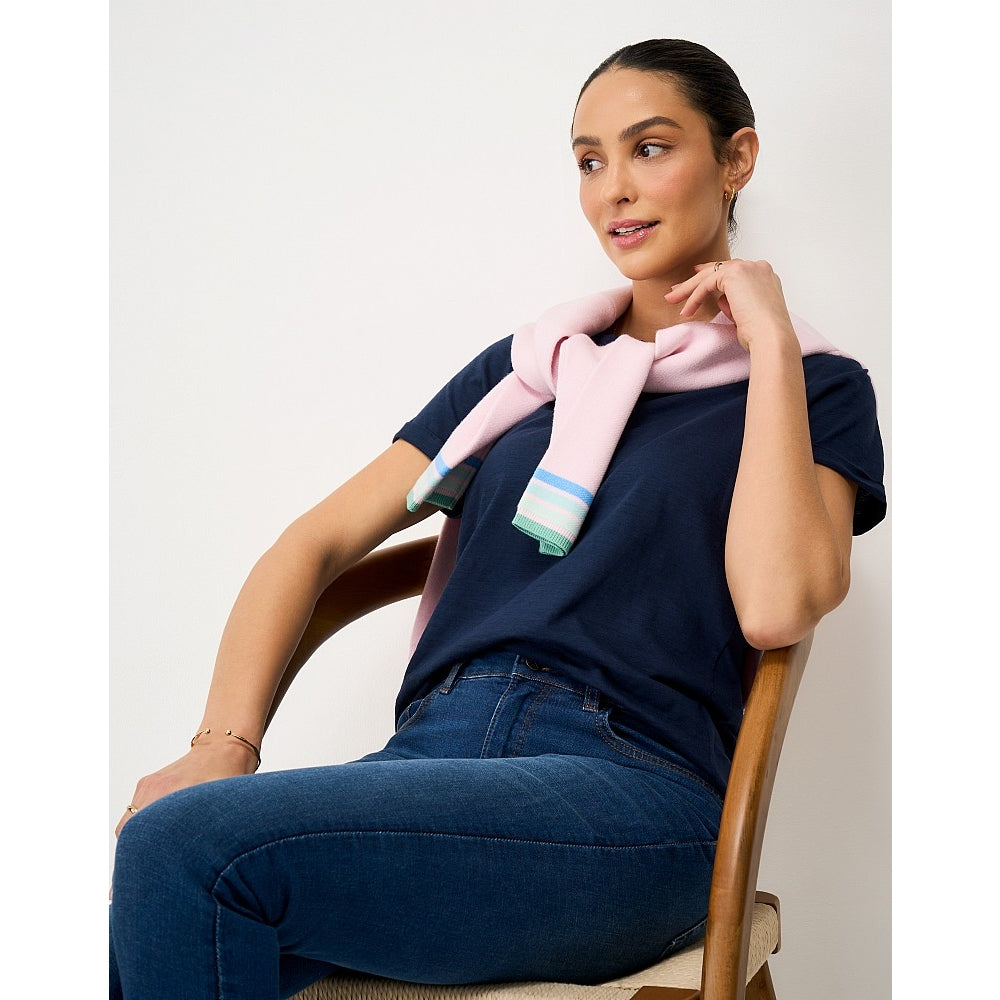 Front view of a woman wearing a Crew Clothing Perfect short sleeve plain t-shirt in navy with jeans and a pink jumper