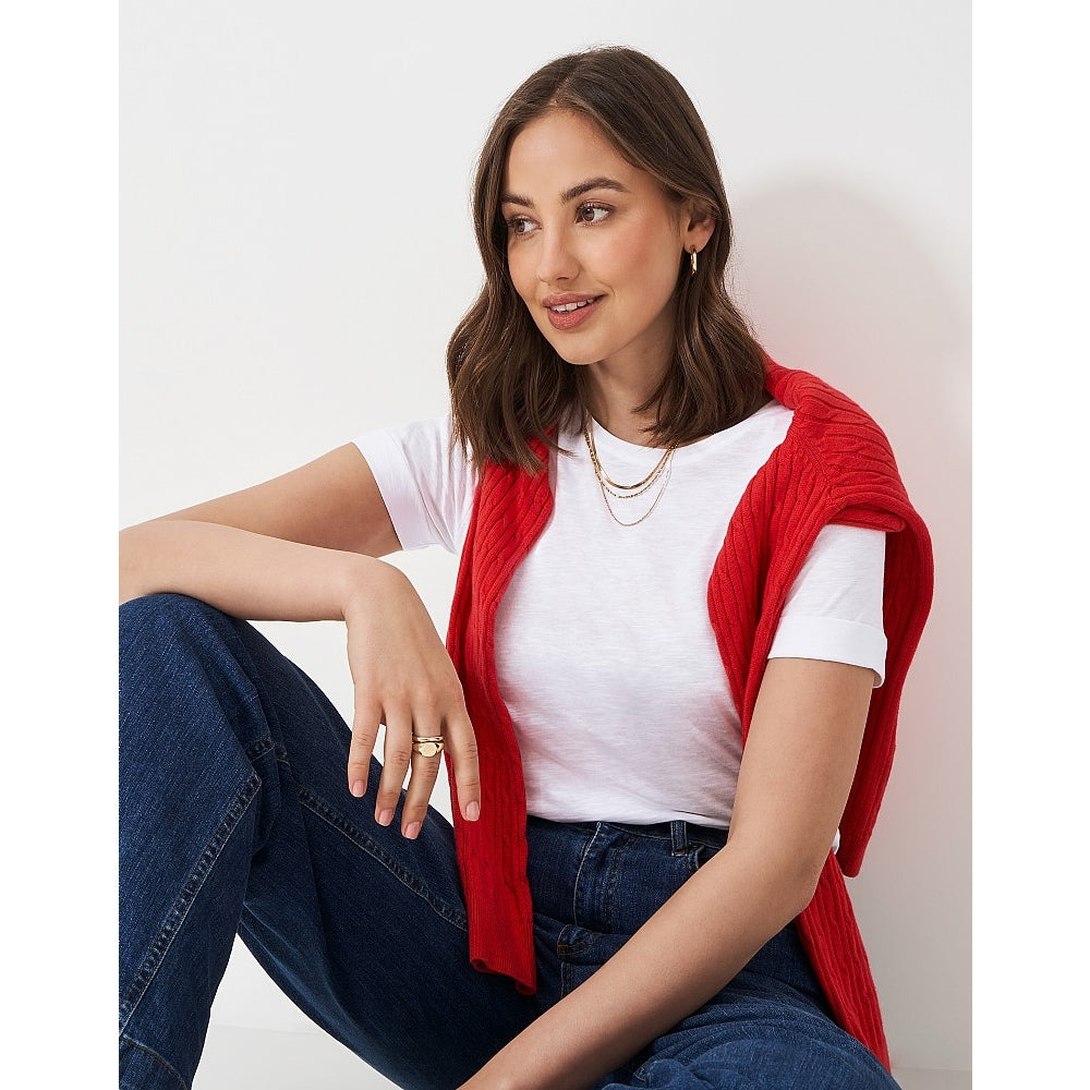 Woman wearing a Crew Clothing Perfect short sleeve plain t-shirt in white, with blue jeans and a red jumper