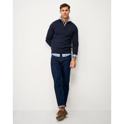 Front view of a man wearing a Crew Clothing 1/4 zip classic knitted jumper in Heritage Navy, jeans and brown shoes.