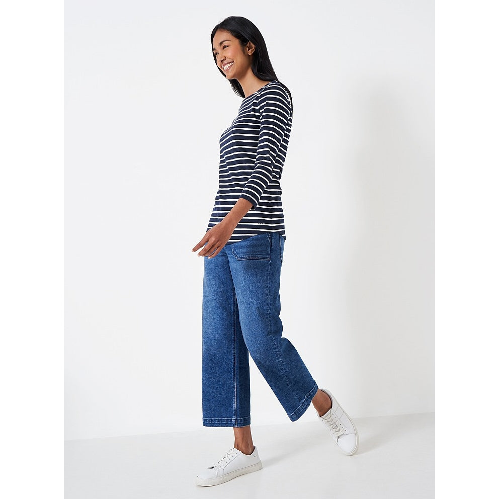 Side view of a woman wearing a Crew Clothing Essential Breton 3/4 sleeve t-shirt in navy with white stripes.