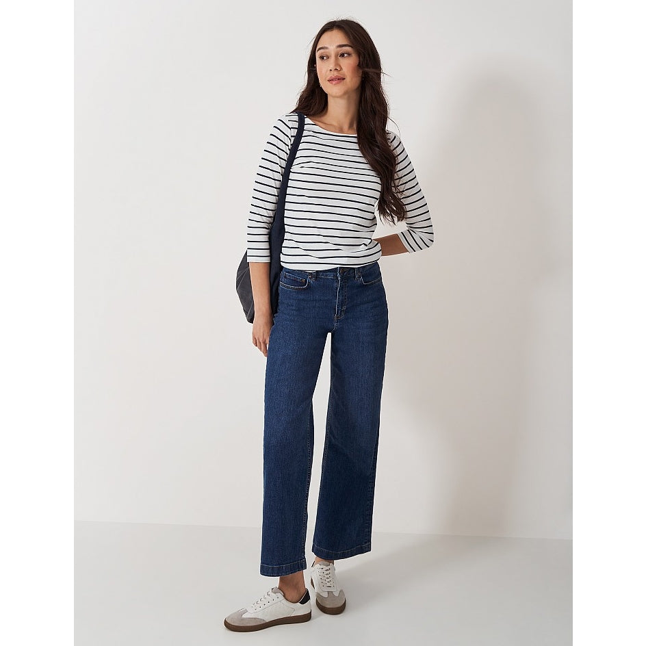 Woman wearing a Crew Clothing Essential Breton 3/4 sleeve t-shirt in white with navy stripes with blue jeans.