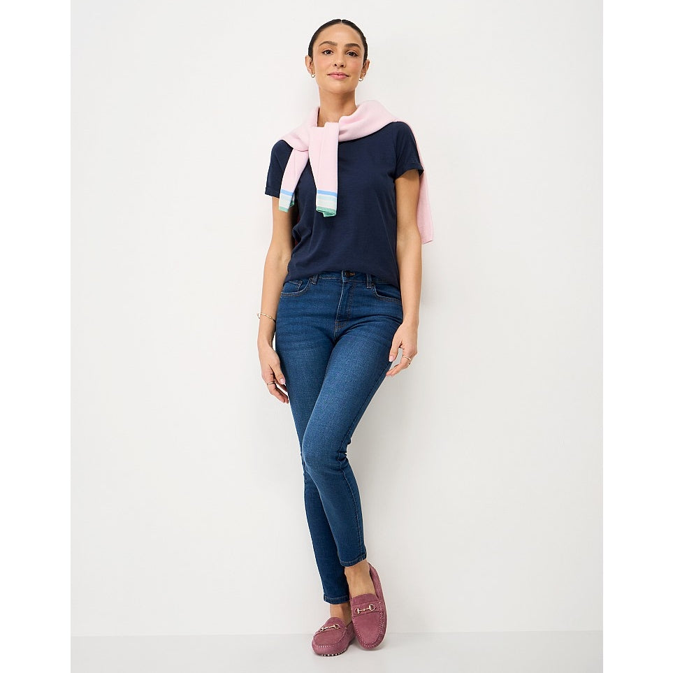 Woman wearing a Crew Clothing Perfect short sleeve plain t-shirt in navy with blue jeans and a jumper tied around her neck